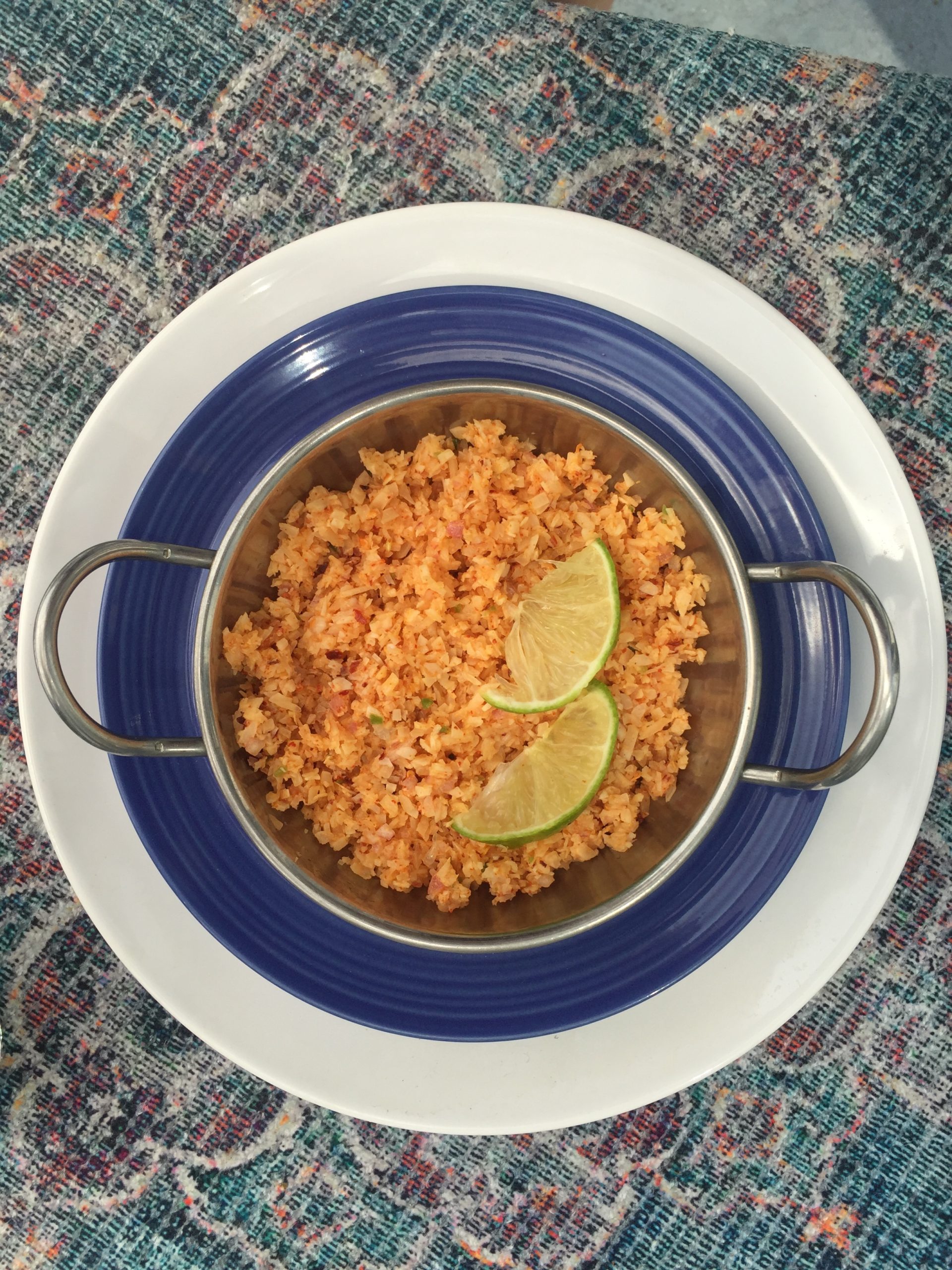 Pol Sambol garnished with lime and served in a silver bowl.